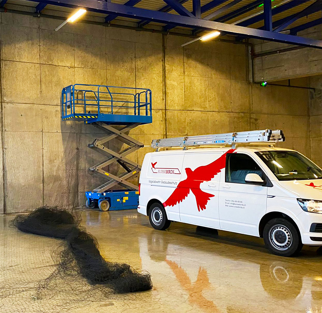 Suisse-Birds-Fahrzeug und Scherenarbeitsbühne in einer Industriehalle